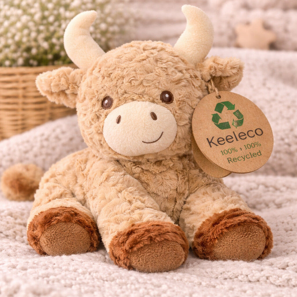 Plush toy highland cow with the legs outstretched infant