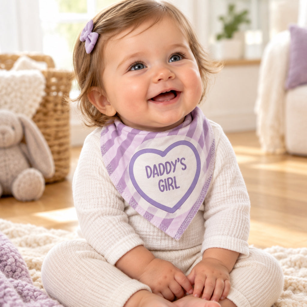 Baby wearing a purple and white striped bandana bib with a Daddy’s Girl heart motif