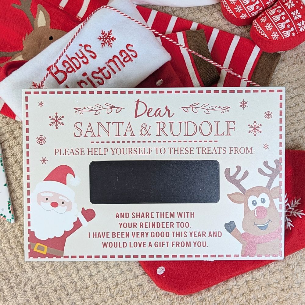 Christmas-themed hanging plaque with Santa and reindeer design on a textured surface.