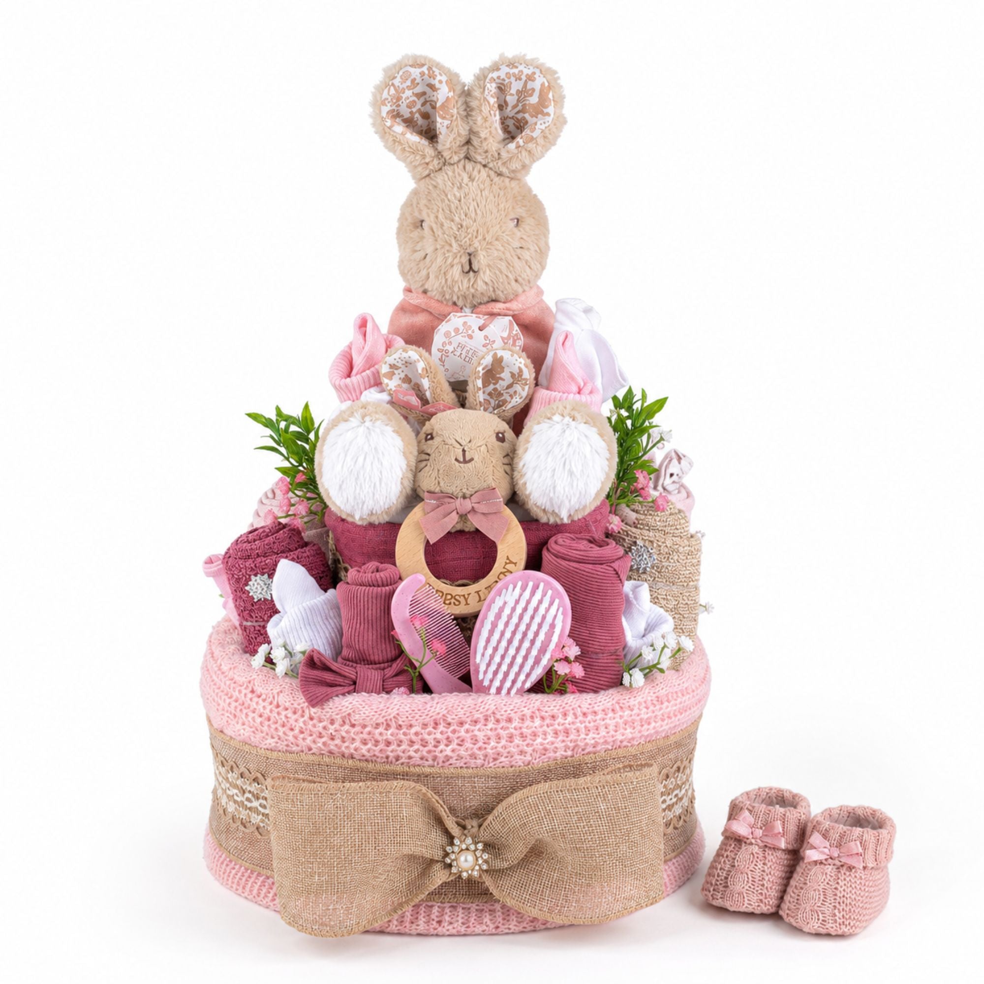 Baby gift nappy cake with flopsy bunny soft toy and pink baby items made to look like a cake