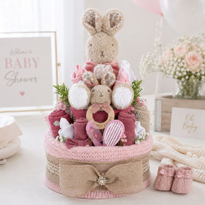 Pink nappy cake, 2 tiers with a bunny on top.