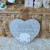Heart-shaped sign with 'Dream Big little one' text and an elephant illustration.