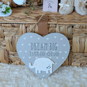 Heart-shaped sign with 'Dream Big little one' text and an elephant illustration.