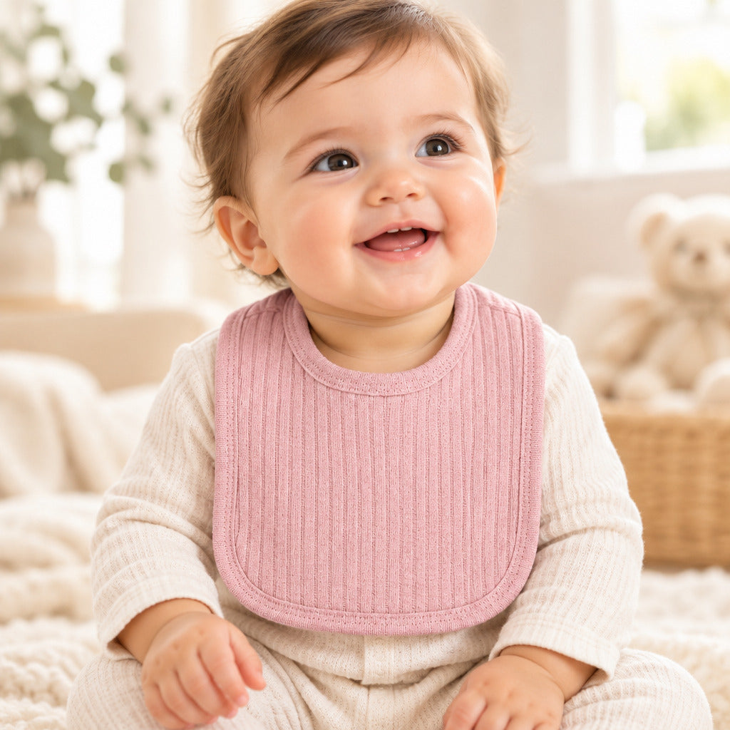 Dusky pink cotton baby bib with Velcro fastening