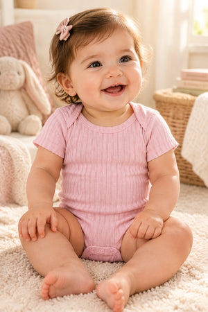 Dusky pink 100% cotton ribbed baby bodysuit detail