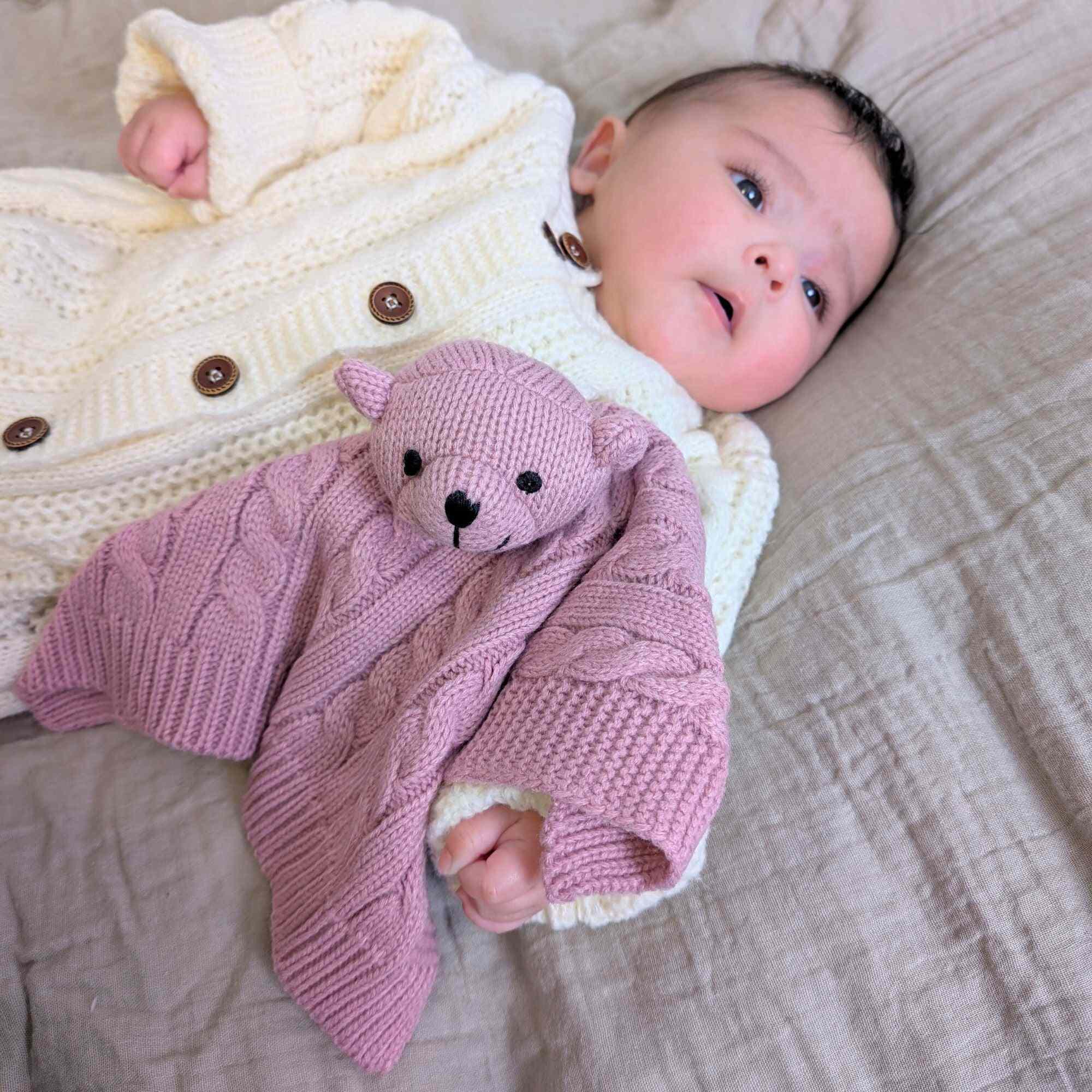 Dusty Pink 'Elegance' Cable Knit Teddy Bear Comforter with a Baby.