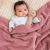Dusky pink waffle baby blanket.