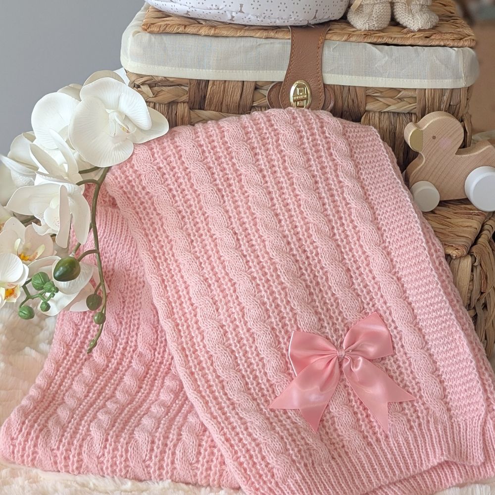 Pink knitted blanket with a bow