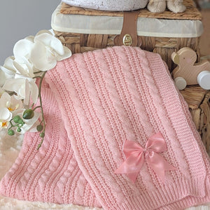 Pink knitted blanket with a bow