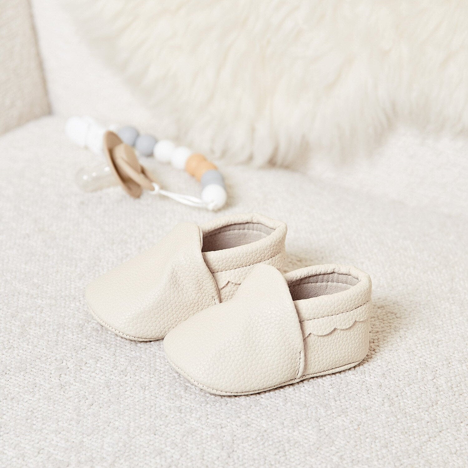 Eggshell Katie Loxton baby shoes in soft vegan leather with scalloped trim, lightweight baby booties for newborn baby clothes styling
