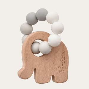 Baby elephant teether featuring a smooth wooden handle and neutral design.