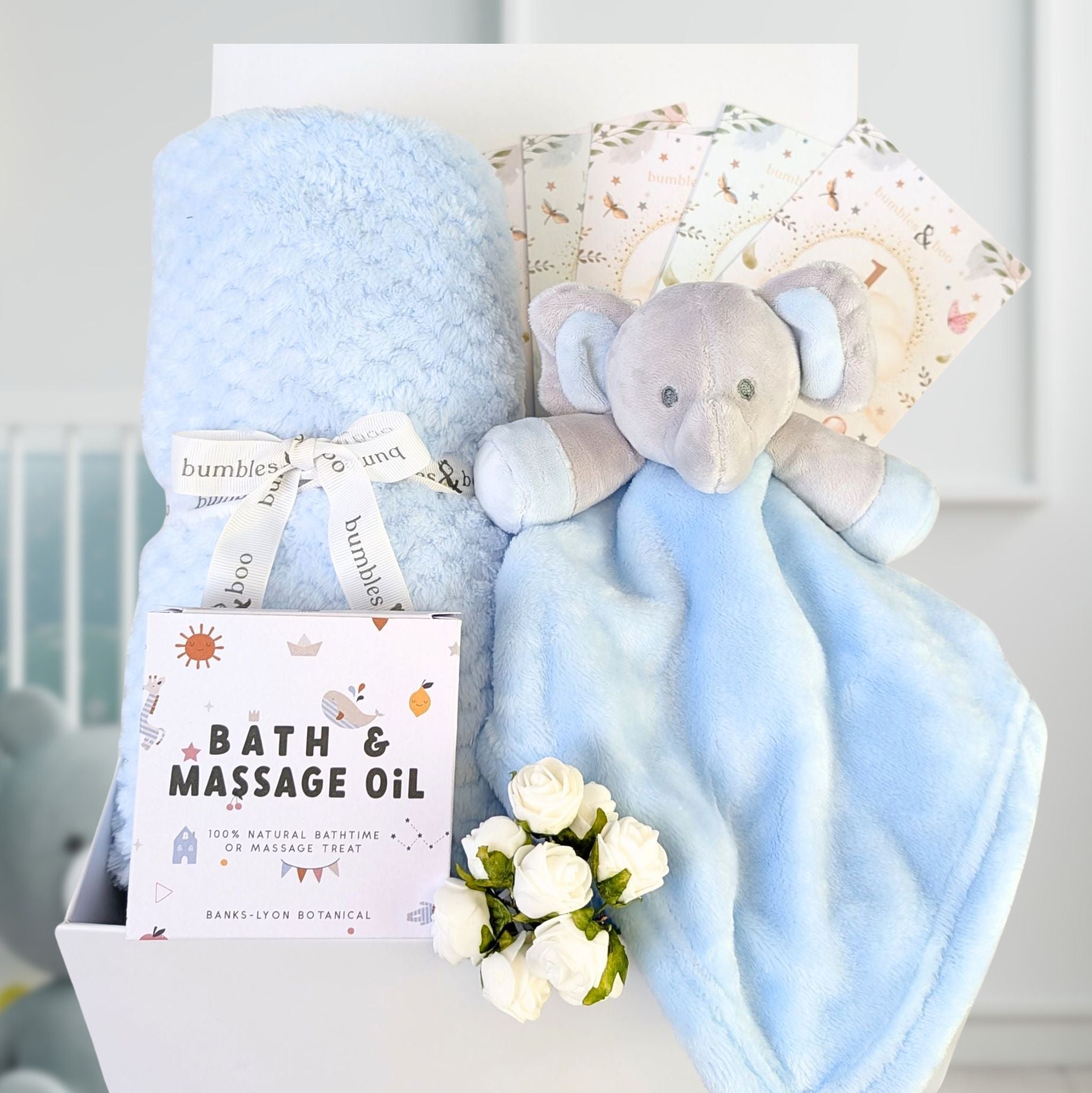 Blue blanket and elephant comforter present for a baby shower.