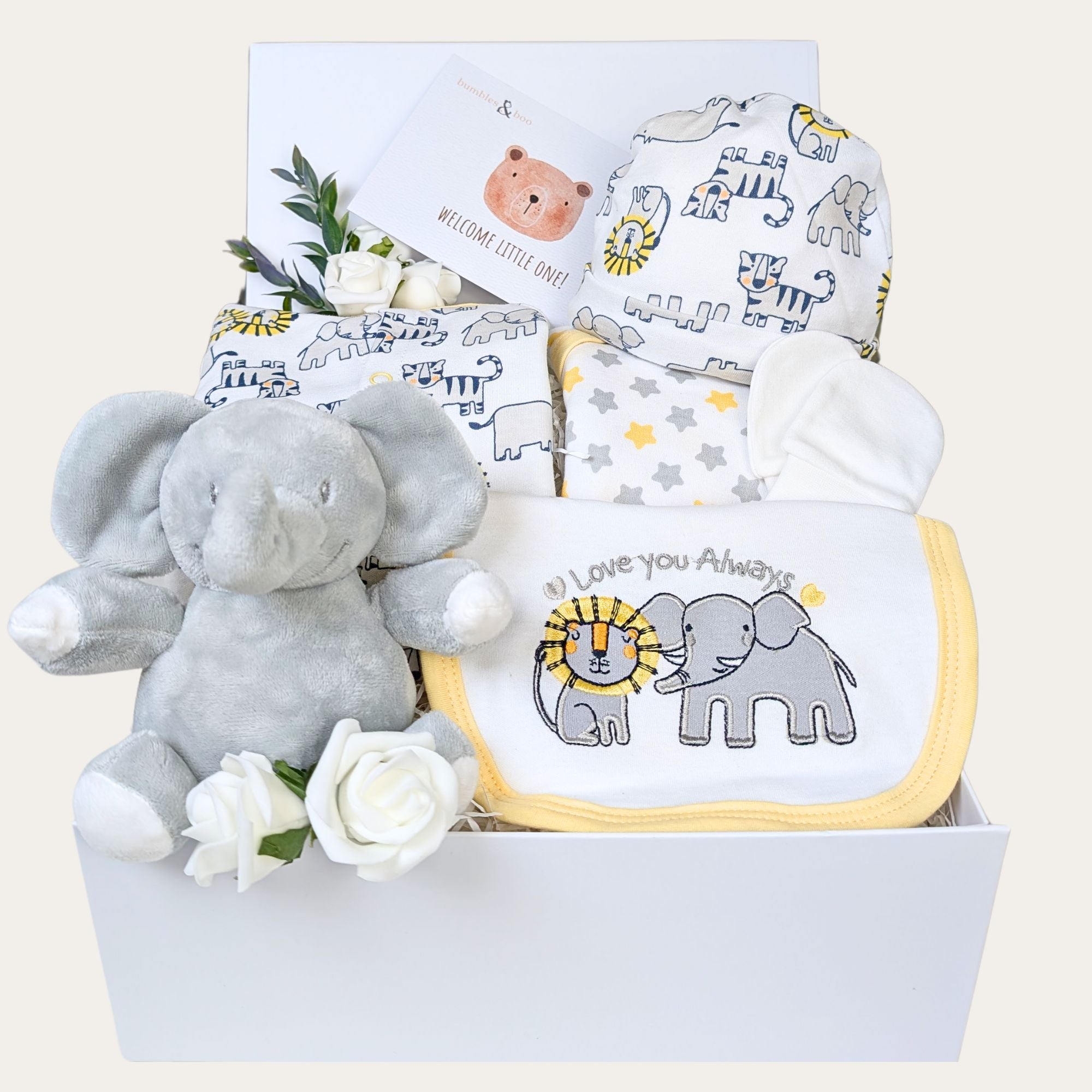 Baby shower gifts box in white. This hamper contains a safari theme white and  yellow baby clothes set and a soft elephant toy. Bumbles and Boo.