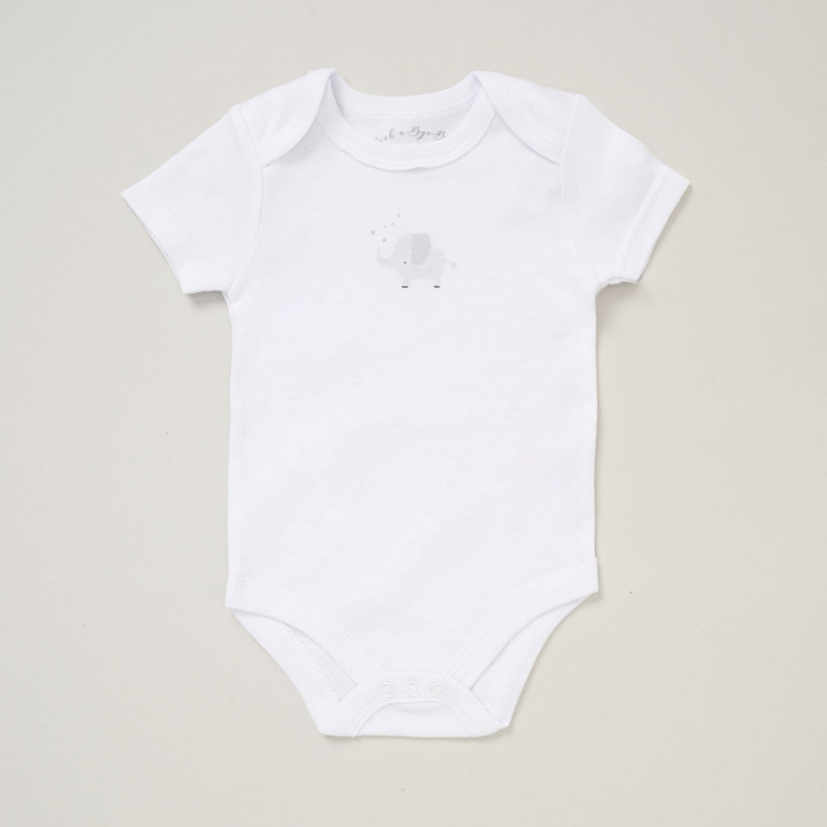 Neutral elephant baby outfit set arranged as a flatlay