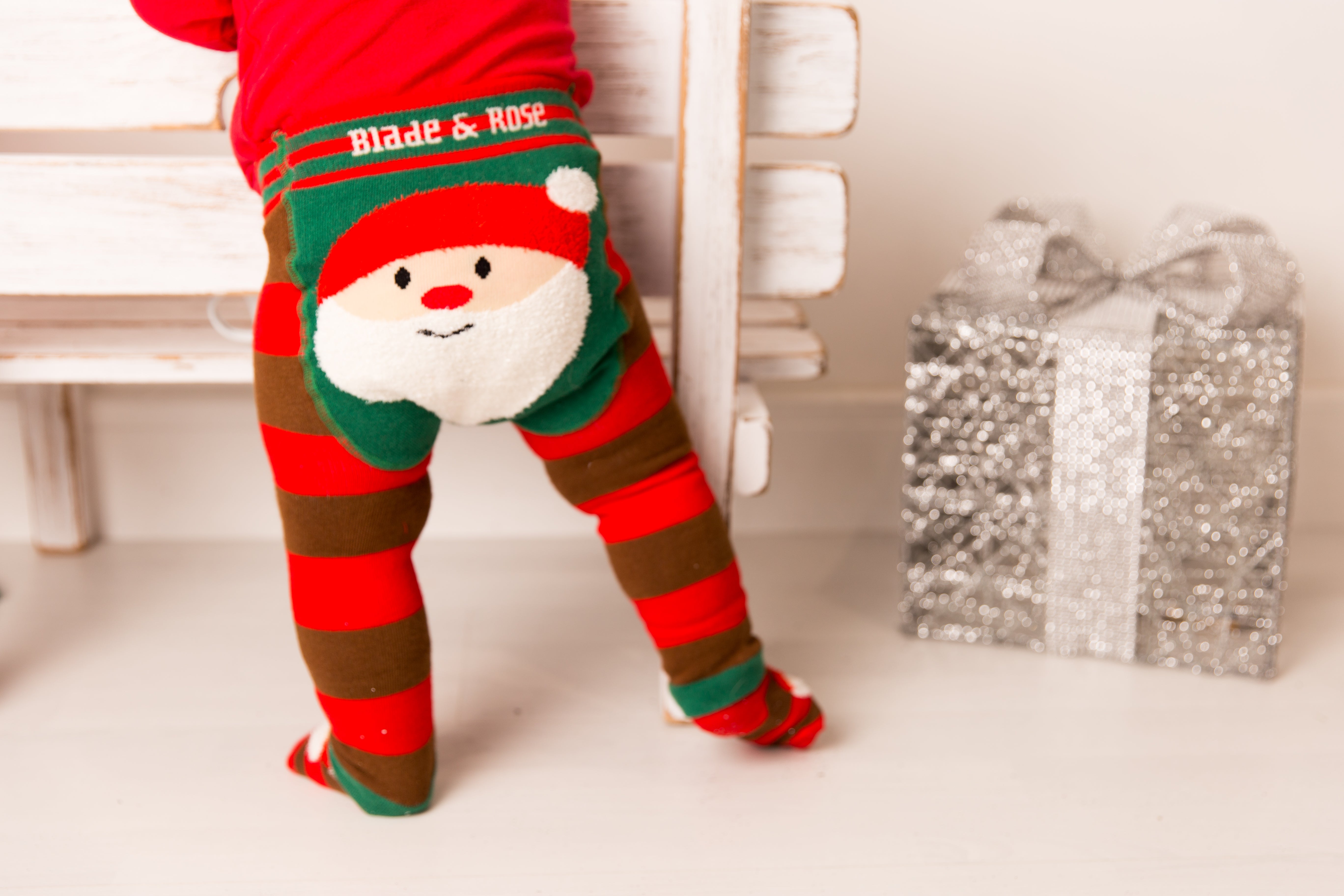 red and brown stopped leggings with a cute Santas Father Christmas face on the bum