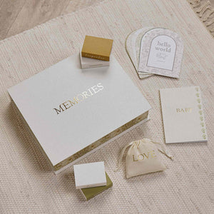 Closed ‘MEMORIES’ baby box with a ‘LOVE’ pouch, record booklet, milestone cards and small boxes.
