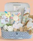 Baby's first birthday gift hamper with soft book, height chart, bunny soft toy and wooden sensory toy.