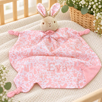 Pink floral baby comforter with bunny soft toy attached to the blanket, embroidered with the name Eva