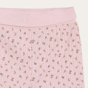 Pink pleated skirt with floral pattern on a white background