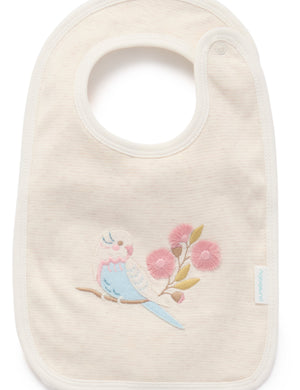 Close up of Flower Garden reversible baby bib in organic cotton with embroidered bird detail. Part of baby clothes set.