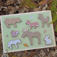 Shape matching wooden baby jigsaw puzzle with forest animals. 
