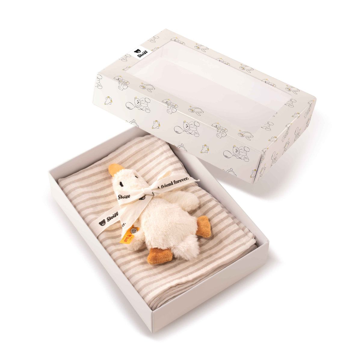 Open presentation box containing the Gilda goose rattle and folded striped burp cloth, with the lid alongside.