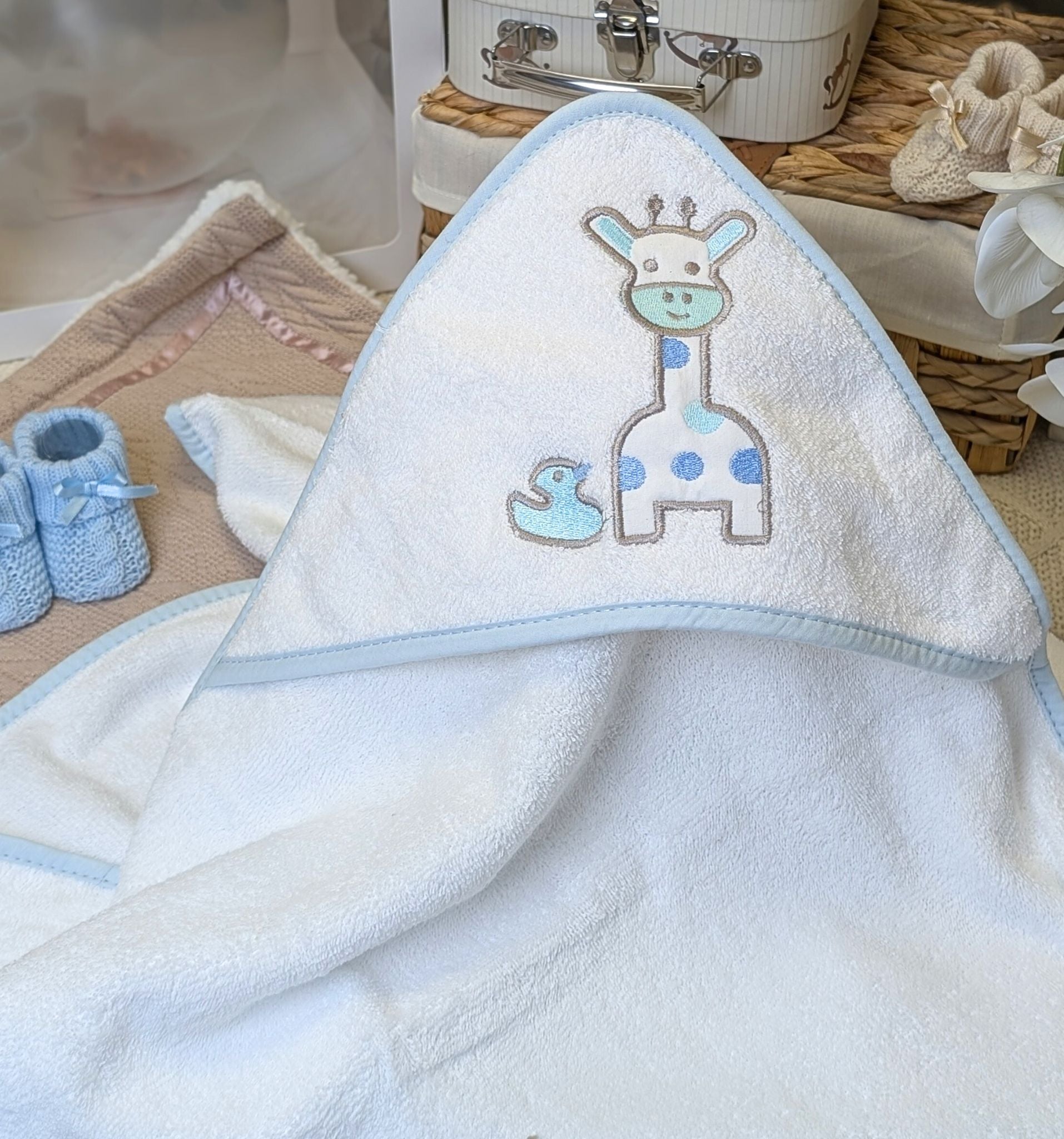 Giraffe baby bath towel in blue white and grey with a little hood.