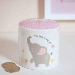 Children's money box with elephant design and pink top on a light background