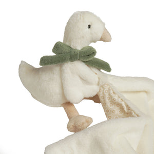 Close-up of plush goose character with green bow and beige beak