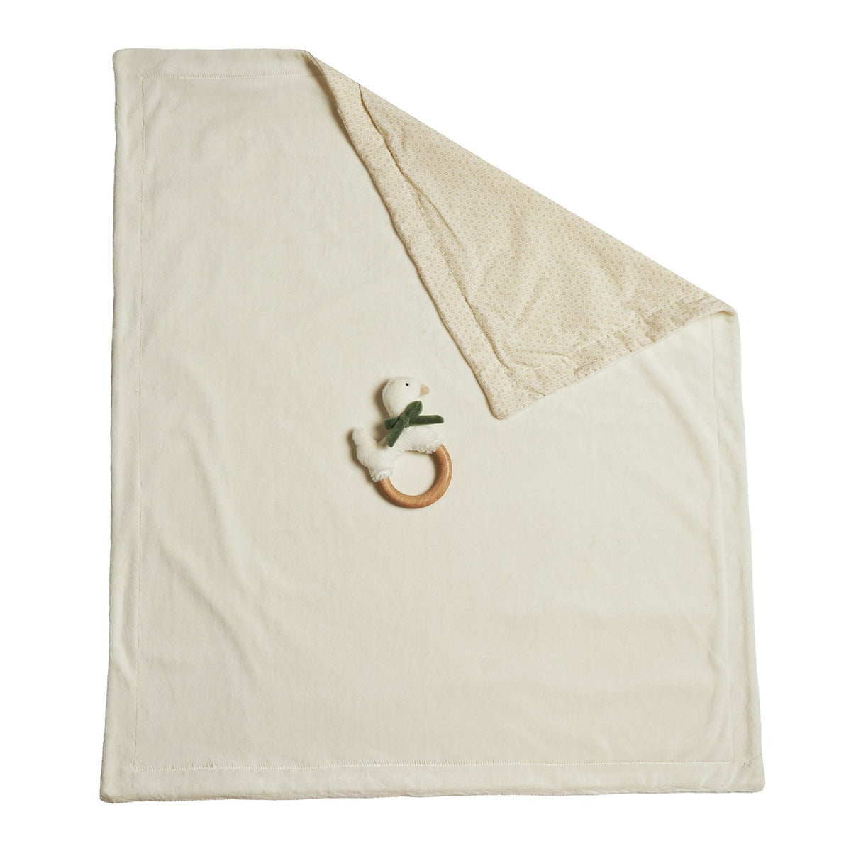 Cream baby blanket and goose wooden ring teether shown together against white.
