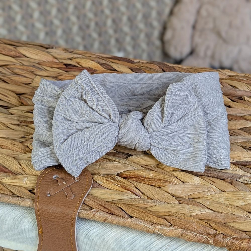 Grey baby headband with a pretty bow.