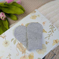 Grey knit baby mittens.