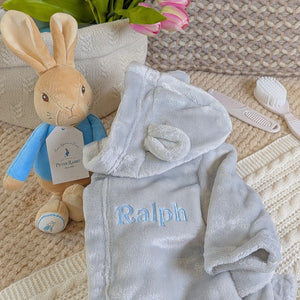 Grey baby bath robe with personalised writing.