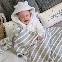 Grey and white striped baby  blanket.