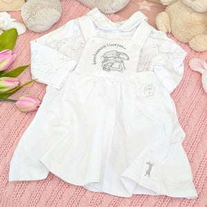 White baby dress with embroidered design. 