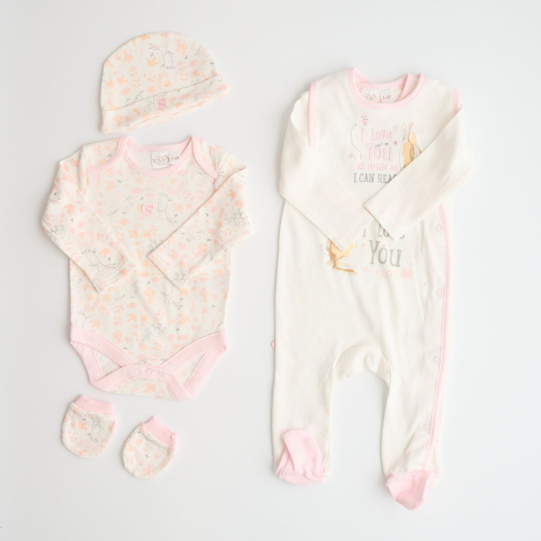 baby clothing set in white and pink with bunny and flowers.