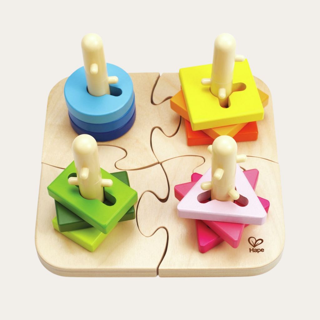Hape Creative Peg Puzzle with blue circles, green squares and pink triangles on an ivory background.