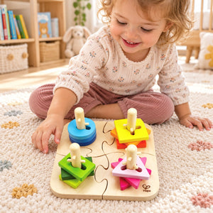 Toddler exploring the Hape Creative Peg Puzzle on a cream play mat in a bright nursery.