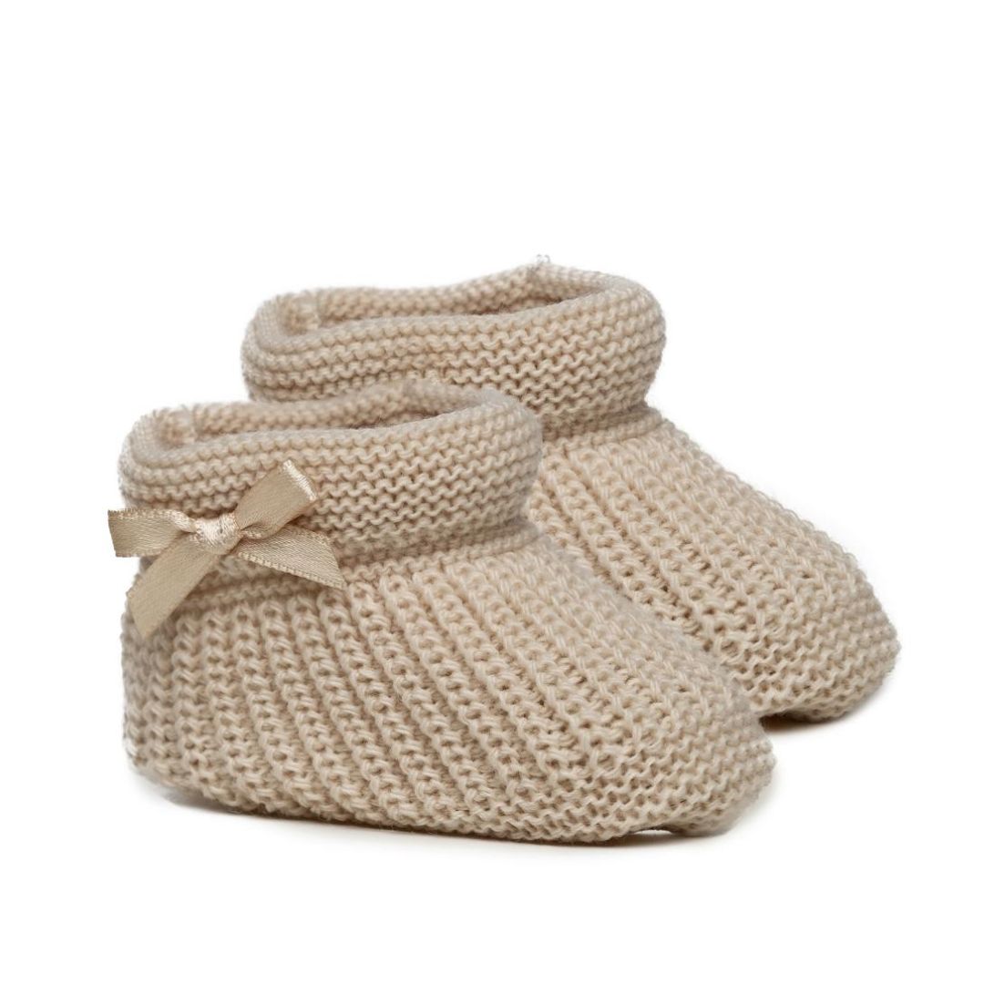 Soft knit biscuit coloured booties with a satin bow
