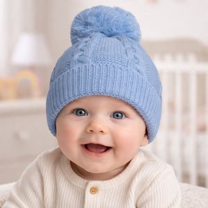 Knit blue baby hat with a pompom