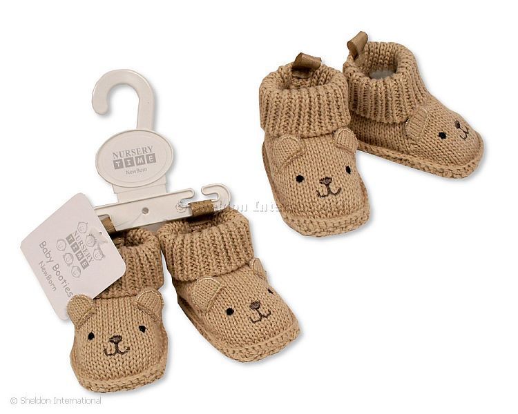 Knitted baby booties with beige bear face embroidery and ears in a soft neutral colour, suitable for newborn babies.