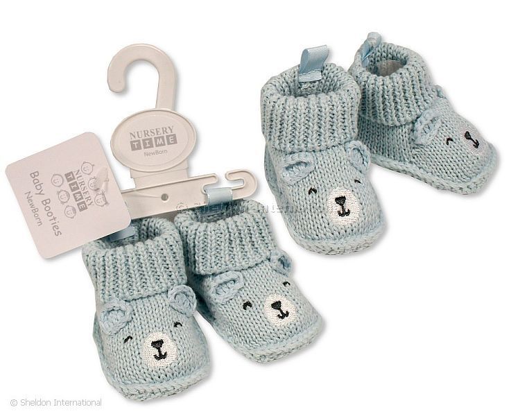 Knitted baby booties with blue bear face embroidery and ears in a soft neutral colour, suitable for newborn babies.