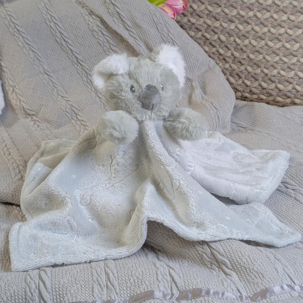 Soft and snuggly koala baby comforter toy with embossed animal print design in grey. 