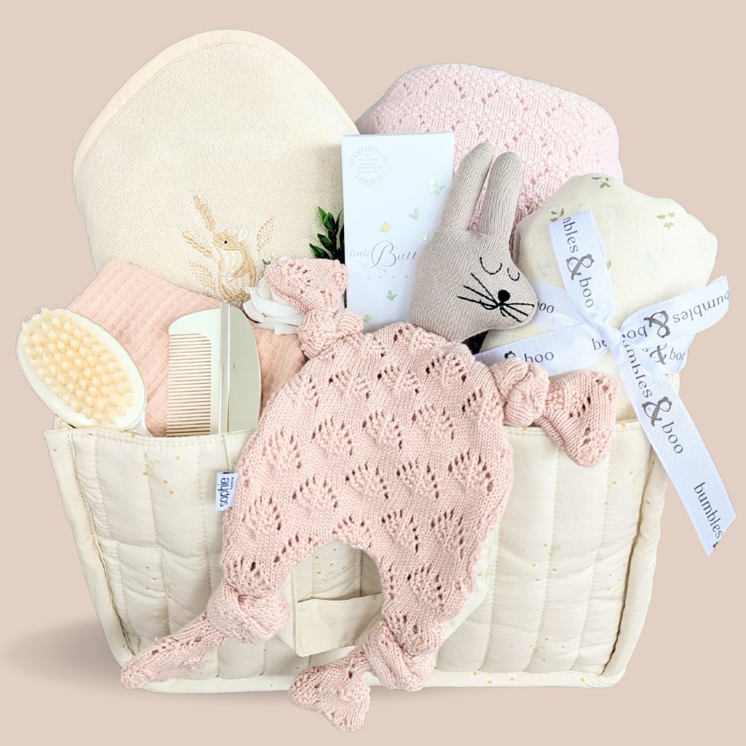 Stunning new baby girl cashmere baby hamper. Beautifully presented in an organic cotton nappy caddy with soft toy, cashmere blanket, organic towel, organic skincare and silver keepsake gift.