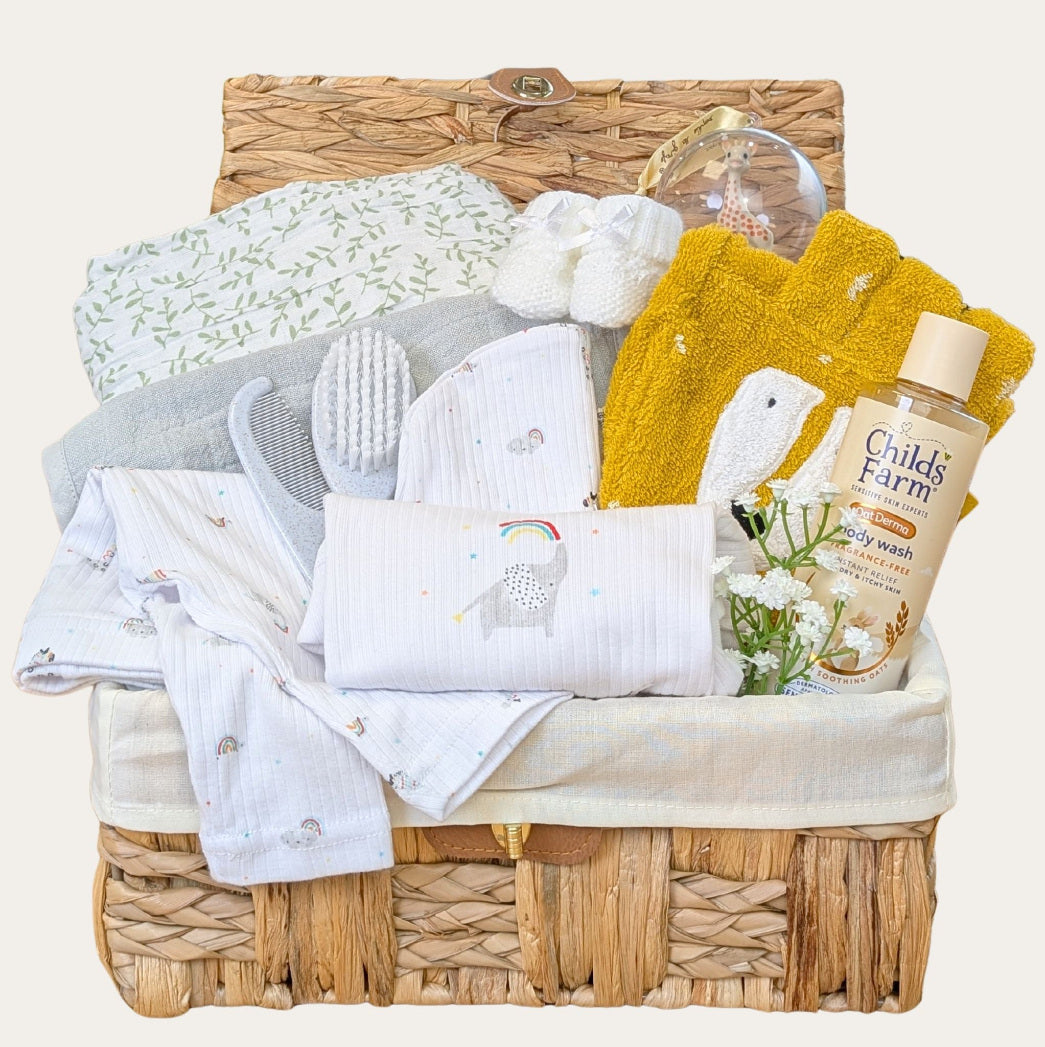 A new baby gifts hamper with clothing and baby essentials.