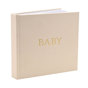 Angled view showing the linen baby album spine and page edges