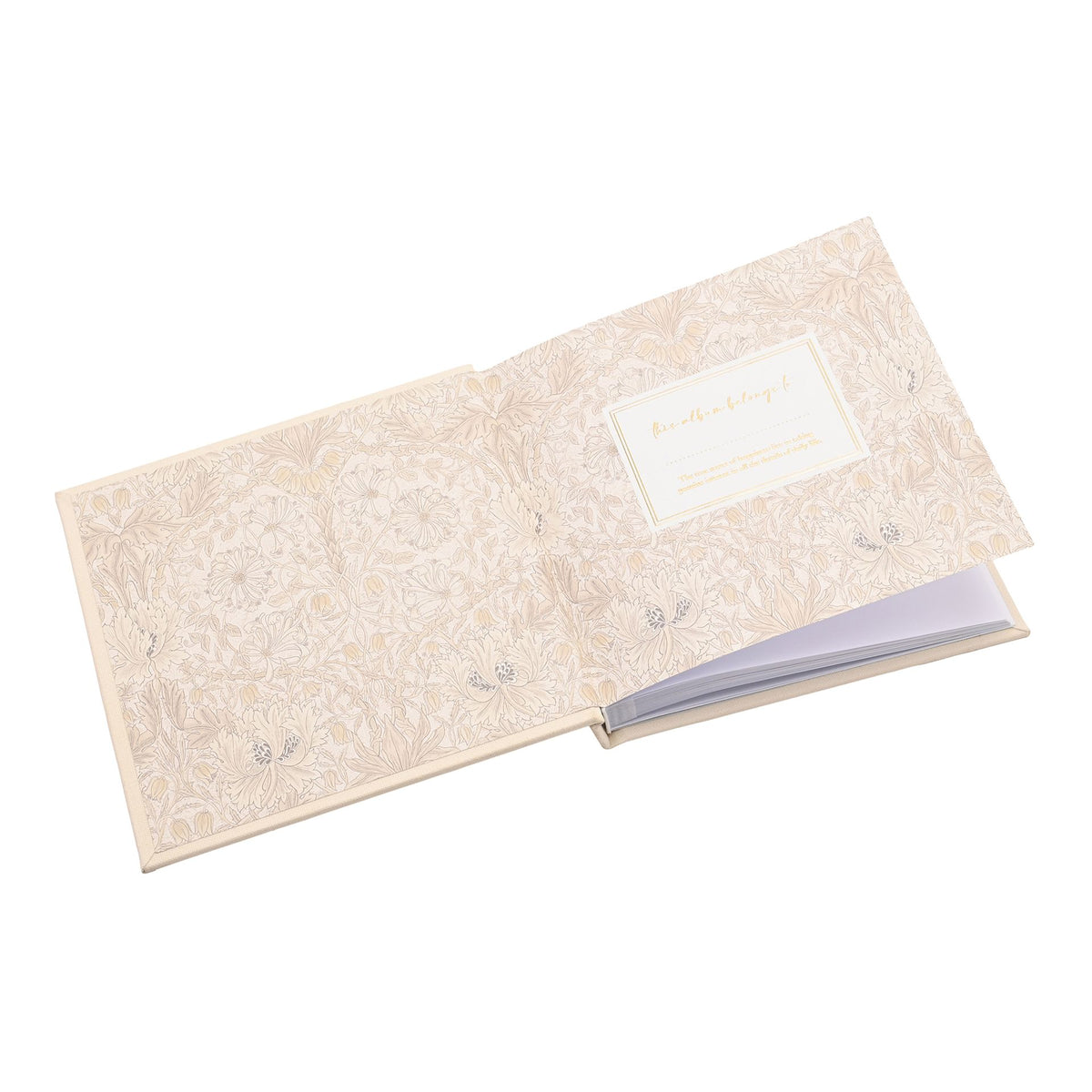 Baby photo album open at patterned endpapers with a dedication panel