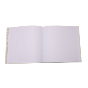 Open memories album displaying blank white photograph pages