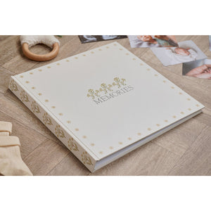 Floral linen memories photo album resting on a wooden surface among photographs