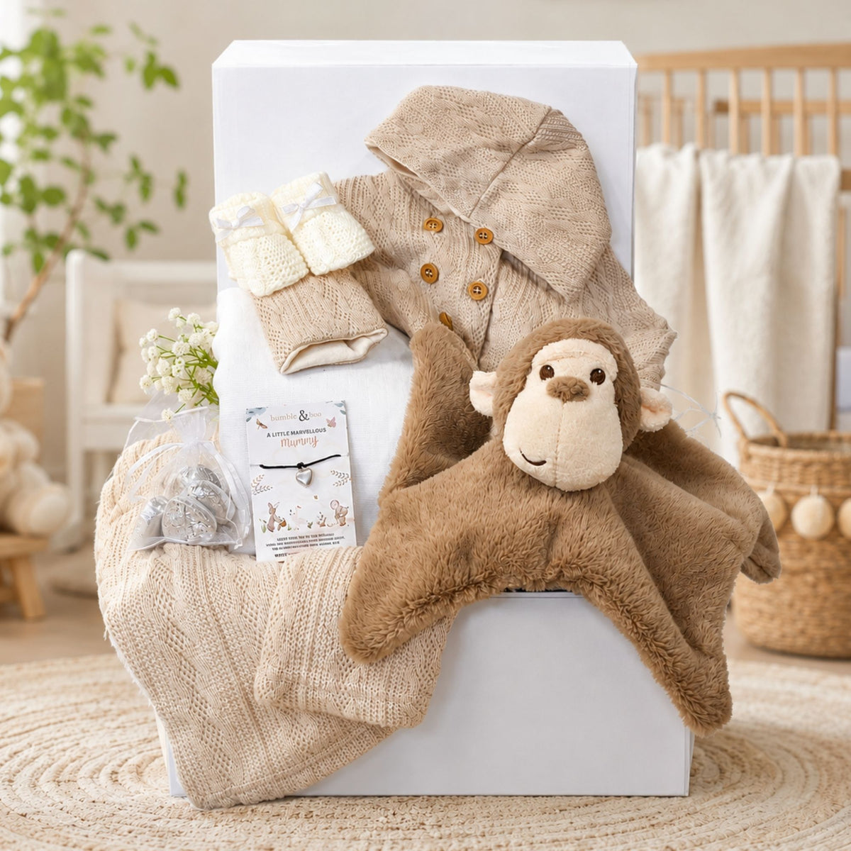 New baby hamper gift set in a box by Bumbles and Boo. Gifts include white baby clothes and a present for mum.